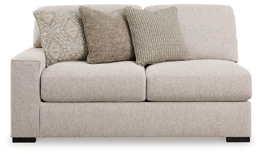 Ashley Furniture Ballyton sectional sofa with plush cushions and modern design, shown in a stylish living room setting.