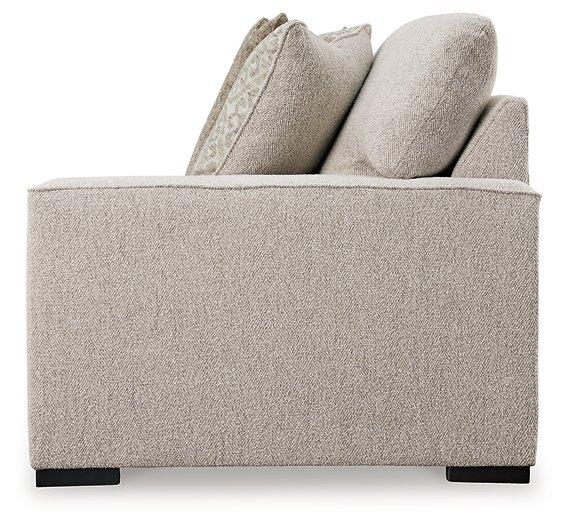 Ashley Furniture Ballyton sectional sofa with plush cushions and modern design in a spacious living room setting.