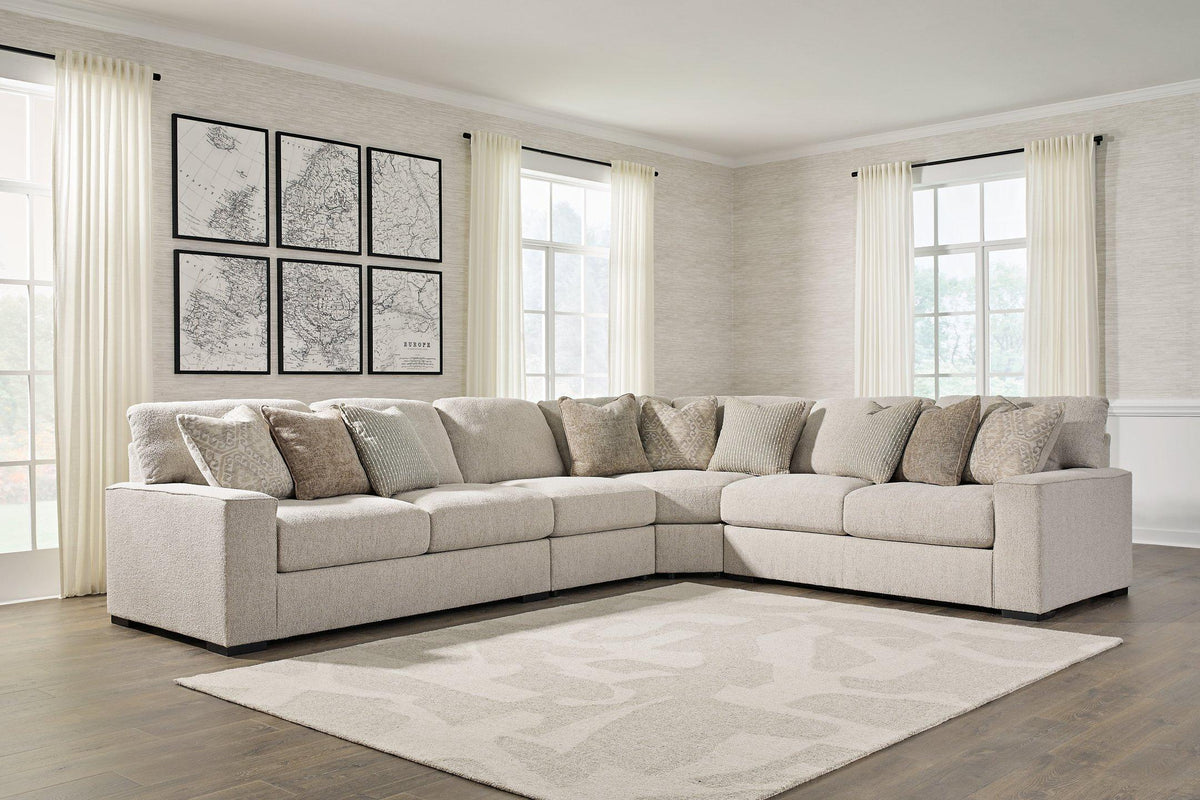 Ashley Furniture Ballyton sectional sofa with neutral fabric and plush cushions, shown in a spacious living room setting.