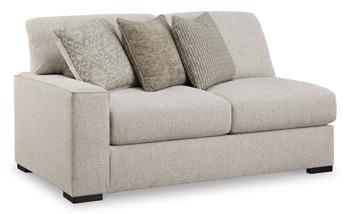 Ashley Furniture Ballyton sectional sofa with plush cushions and modern design in a cozy living room setting.