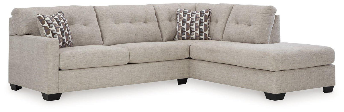 Ashley Mahoney 2-piece sleeper sectional with chaise, featuring plush cushions and modern design for comfortable living space.