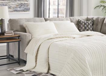 Ashley Mahoney 2-piece sleeper sectional with chaise, featuring plush upholstery and modern design, perfect for living room seating.