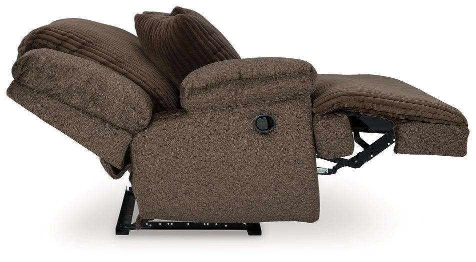 Ashley Furniture Top Tier reclining sectional sofa with chaise, featuring plush cushions and modern design in a cozy living room setting.