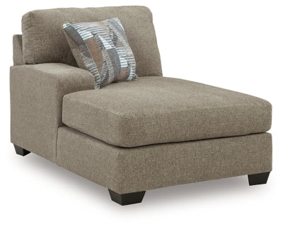 Ashley Furniture Newellen sectional with double chaise, showing a spacious L-shaped sofa with plush cushions and neutral upholstery.