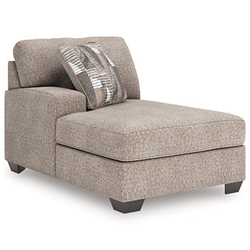 Ashley Furniture Newellen Super Chaise sectional with plush upholstery, shown from an angled view highlighting its spacious seating.
