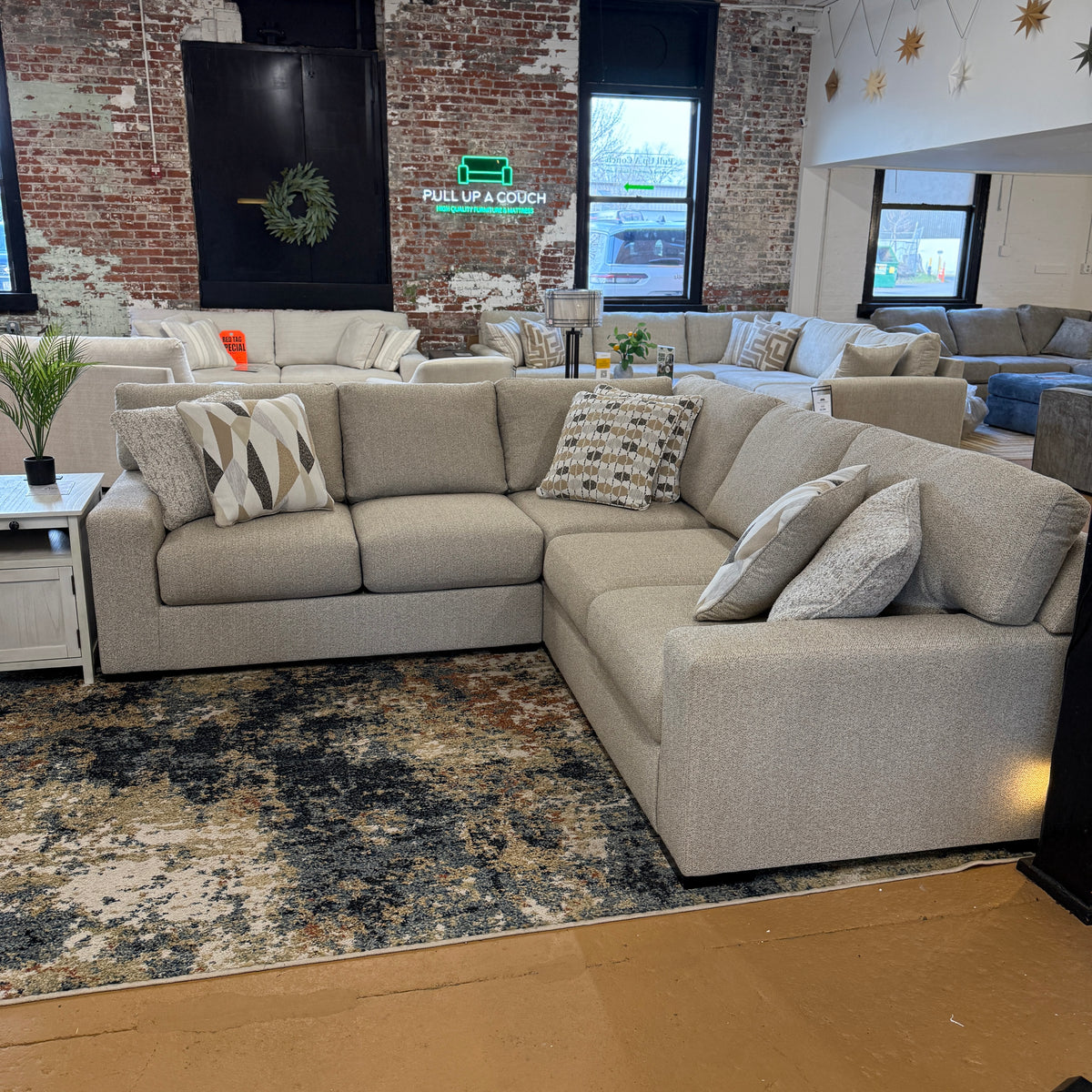 Silverwood corner sectional and ottoman by Ashley Furniture, featuring plush gray upholstery and modern design.