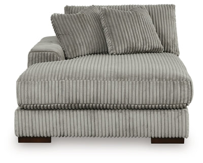 Ashley Furniture Lindyn sectional with chaise, showcasing beige fabric upholstery and plush cushions in a modern living room setting.