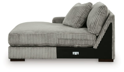 Ashley Furniture Lindyn sectional with chaise, featuring plush upholstery and modern design, shown in a spacious living room setting.