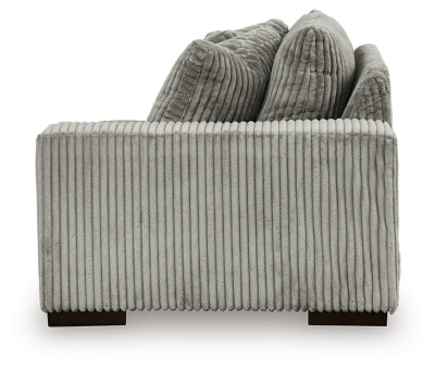 Ashley Furniture Lindyn sectional with chaise, featuring plush upholstery and modern design, shown from the side view.