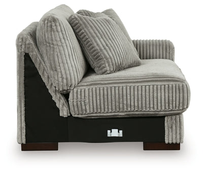 Ashley Furniture Lindyn sectional with chaise, featuring plush fabric and modern design, shown in a cozy living room setting.