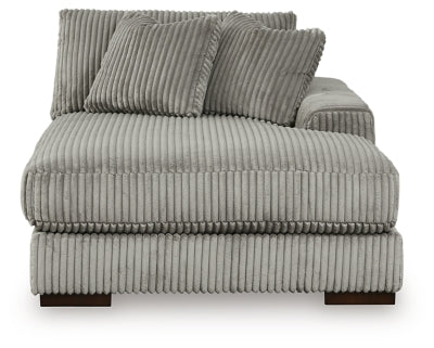 Ashley Furniture Lindyn sectional with chaise, beige fabric, plush cushions, and modern design in a cozy living room setting.