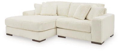 Ashley Furniture Lindyn sectional with chaise in neutral fabric, showcasing modern design and comfortable seating arrangement.