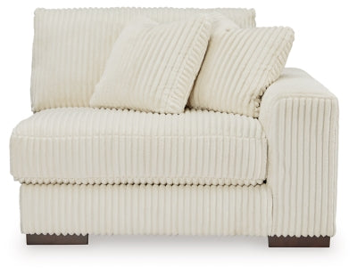 Ashley Furniture Lindyn sectional with chaise, showcasing a comfortable fabric sofa with plush cushions and a modern design.