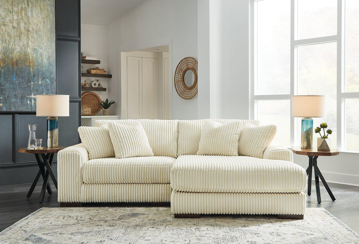 Ashley Furniture Lindyn sectional with chaise, showing plush fabric, modern design, and spacious seating in a contemporary living room setting.