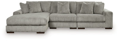 Ashley Furniture Lindyn sectional with chaise, featuring plush fabric upholstery and modern design, shown in a living room setting.