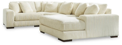 Ashley Furniture Lindyn sectional with chaise, featuring plush fabric and modern design, shown in a cozy living room setting.
