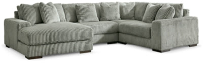 Ashley Furniture Lindyn sectional with chaise, showcasing plush fabric upholstery and modern design in a spacious living room setting.