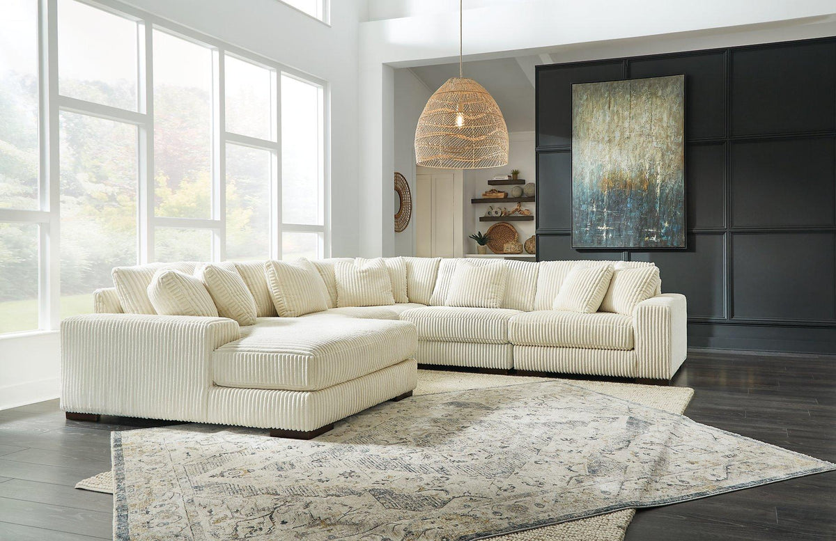 Ashley Furniture Lindyn sectional with chaise, plush fabric, and modern design, shown in a cozy living room setting.