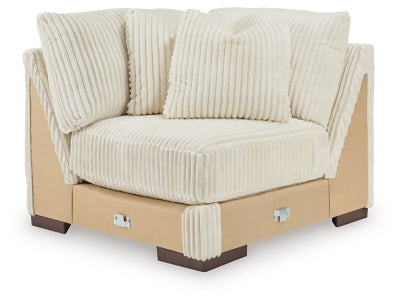 Ashley Furniture Lindyn sectional with chaise, beige fabric, contemporary design, featuring plush cushions and a spacious seating area.