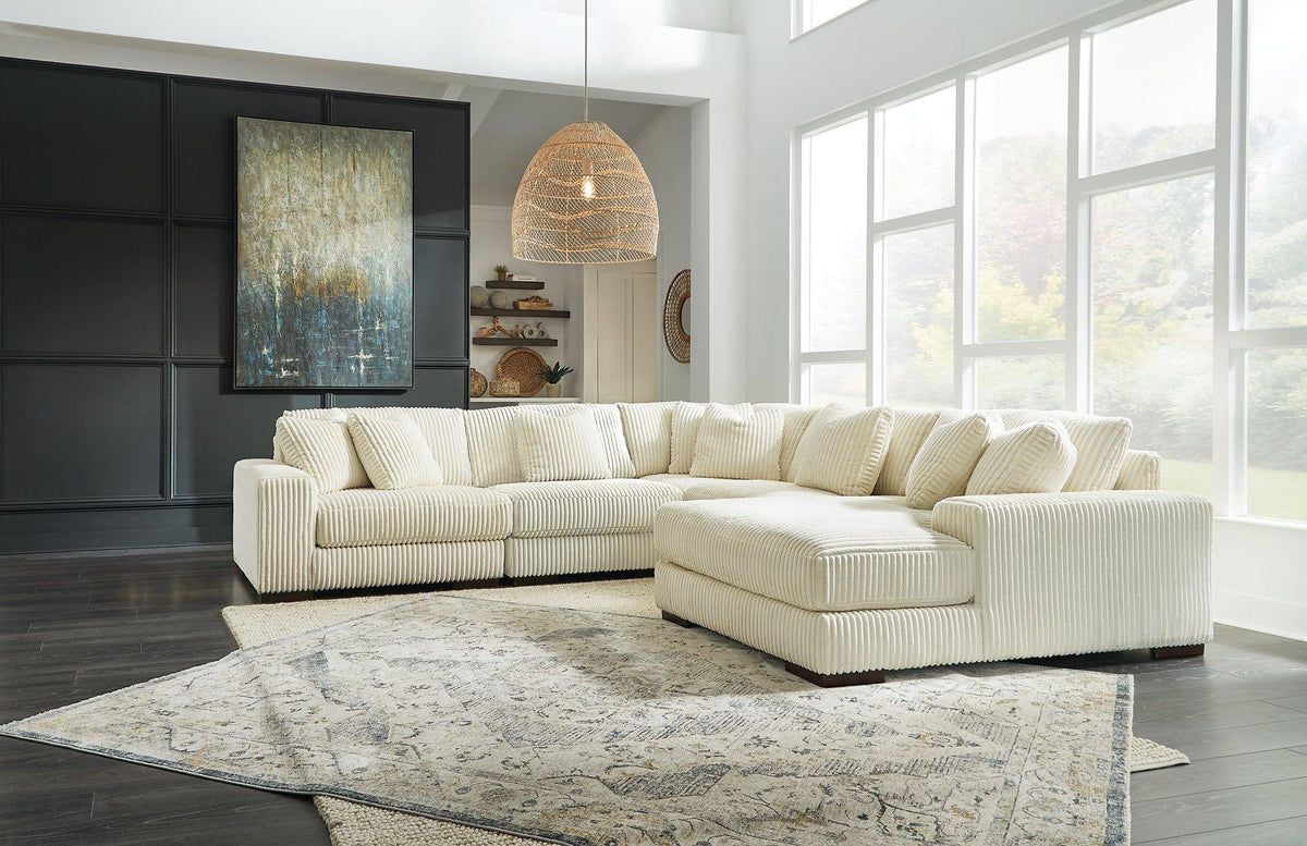 Ashley Furniture Lindyn sectional with chaise, showing a modern fabric sofa with a spacious chaise lounge in a stylish living room setting.
