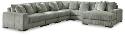 Ashley Furniture Lindyn sectional with chaise, featuring plush fabric, modern design, and multiple seating areas.