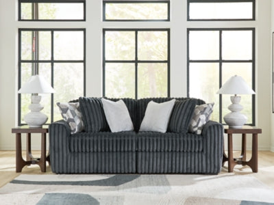Ashley Furniture Midnight-Madness sectional sofa with plush cushions and modern design, shown in a living room setting.