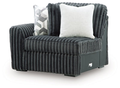 Ashley Furniture Midnight-Madness sectional sofa shown from an angle, upholstered in dark fabric with plush cushions and modern design.