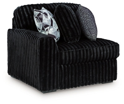 Ashley Furniture Midnight-Madness sectional sofa in dark fabric, shown from an angled view highlighting its modern design.