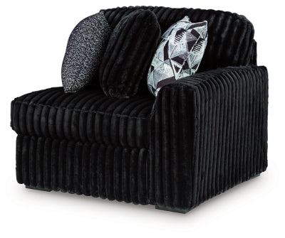 Ashley Furniture Midnight-Madness sectional sofa shown from an angled view, featuring plush cushions and modern design.