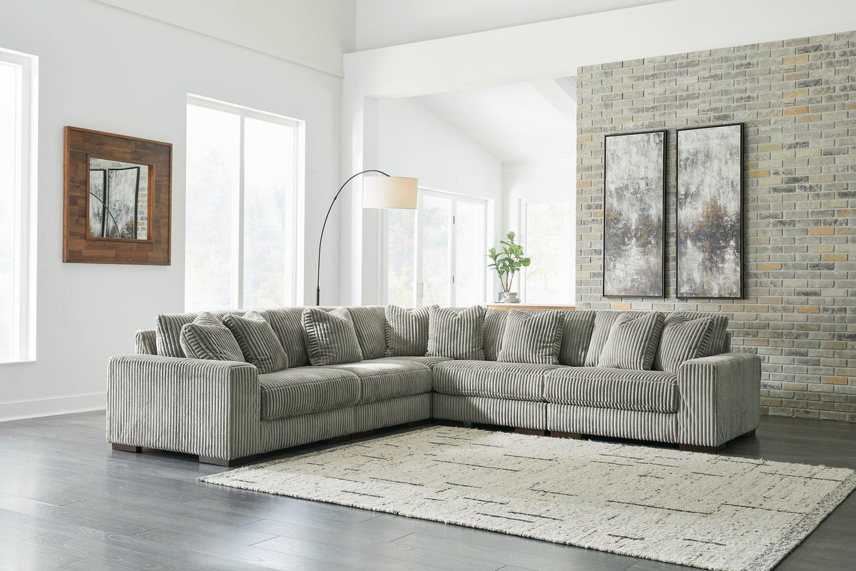 Ashley Furniture Lindyn sectional sofa with plush cushions and neutral fabric, shown in a modern living room setting.