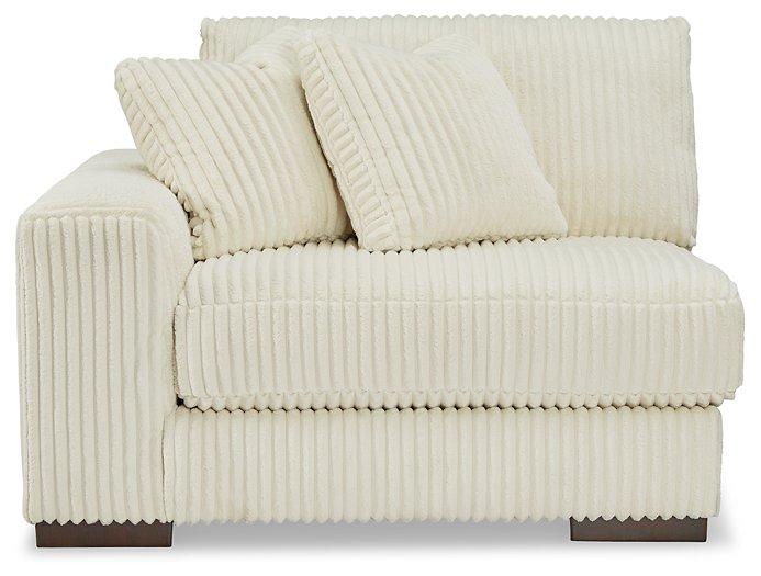 Ashley Furniture Lindyn sectional sofa with plush cushions and neutral fabric, shown in a modern living room setting.