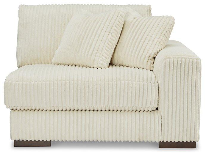 Ashley Furniture Lindyn sectional sofa with plush fabric and modern design, featuring multiple seating areas and a neutral color.
