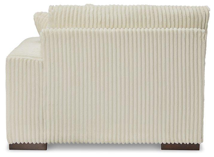 Ashley Furniture Lindyn sectional sofa with plush cushions and modern design, shown in a spacious living room setting.