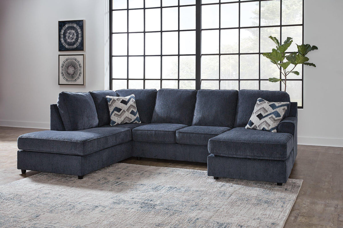 Ashley Furniture Albar Place sectional sofa with plush cushions and modern design, shown in a cozy living room setting.