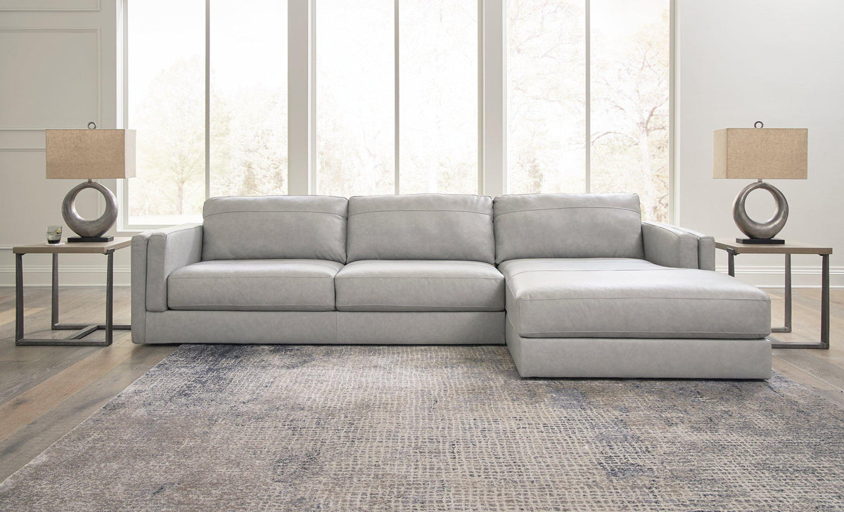Ashley Furniture Amiata sectional with chaise, showing plush fabric upholstery and modern design in a spacious living room setting.