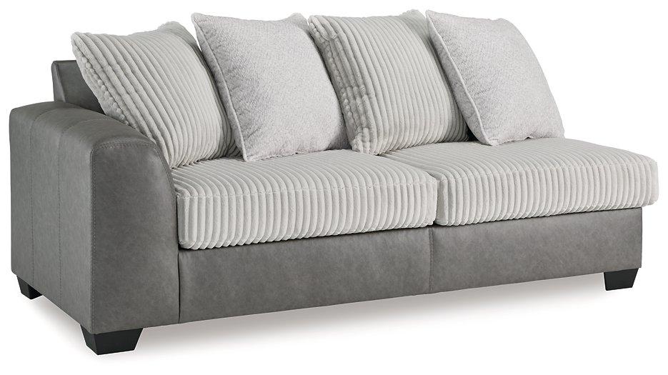 Ashley Furniture Clairette Court sectional with chaise, featuring plush upholstery and modern design in a spacious living room setting.