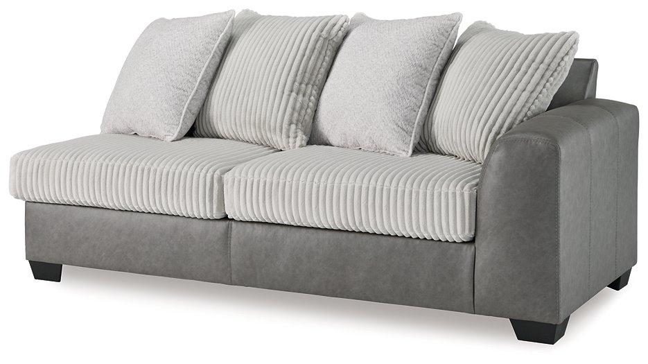 Ashley Furniture Clairette sectional with chaise, featuring neutral fabric upholstery and plush cushions for comfortable seating.