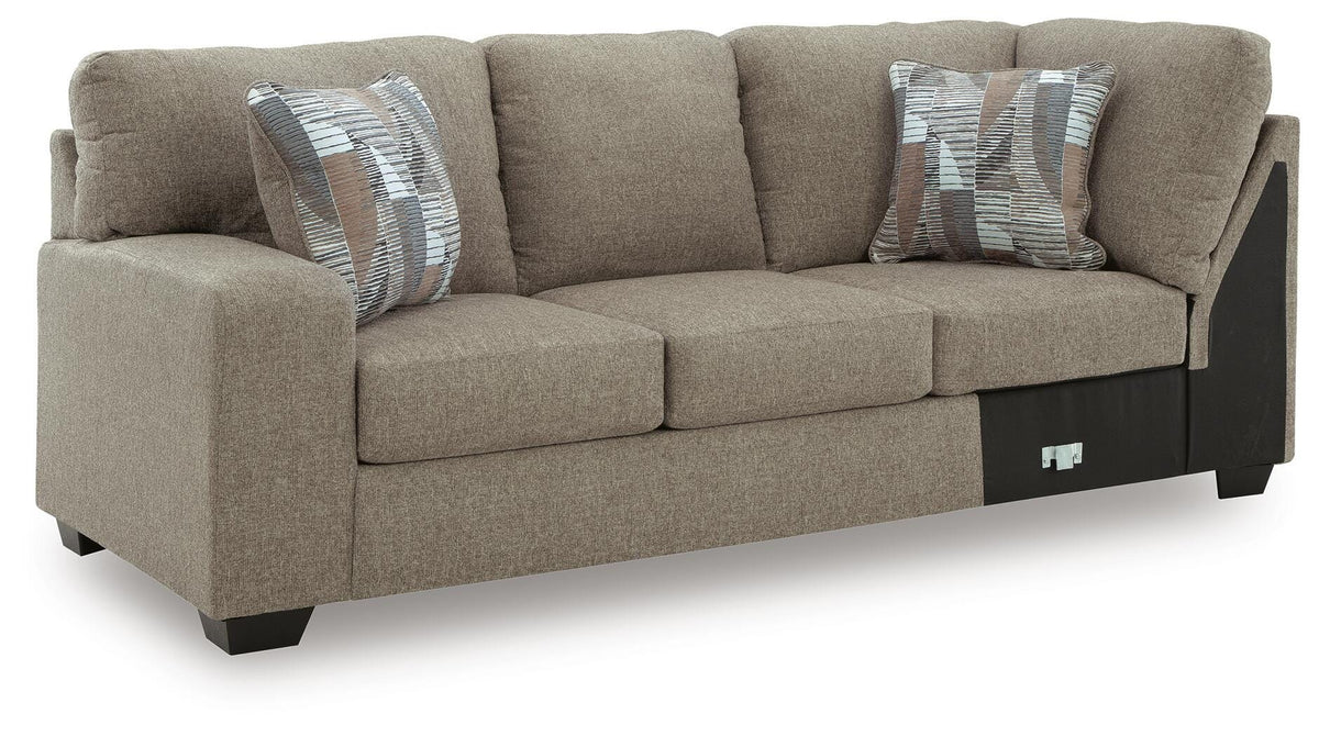 Ashley Furniture Newellen sleeper sectional with chaise, featuring plush upholstery and modern design, shown from an angled side view.