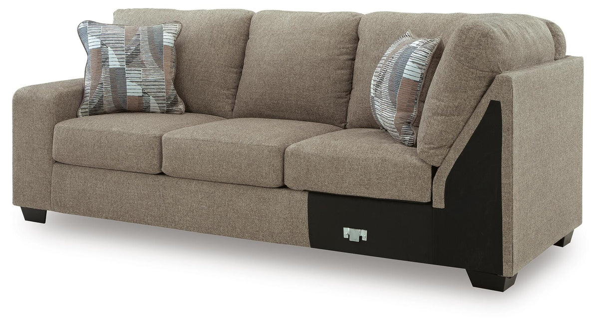 Ashley Furniture Newellen Sleeper Sectional with chaise, featuring plush upholstery and a modern design, shown from an angled side view.