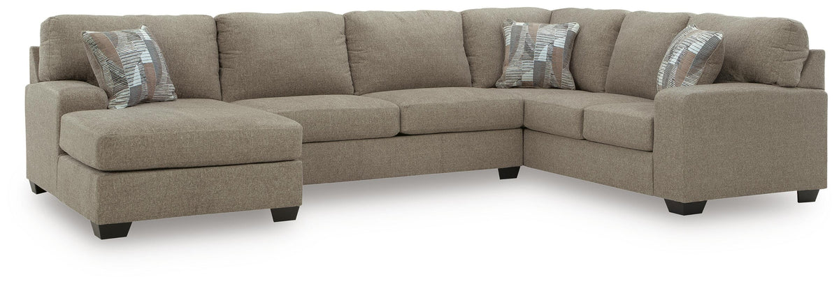 Ashley Furniture Newellen sleeper sectional with chaise, featuring plush upholstery and a spacious lounging area.