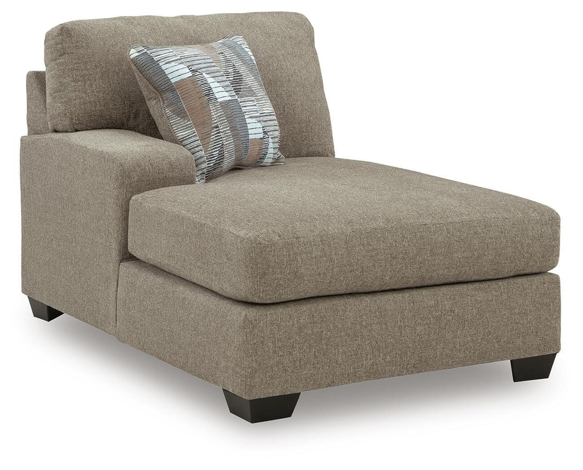 Ashley Furniture Newellen sleeper sectional with chaise, featuring plush cushions and a modern design in a cozy living room setting.