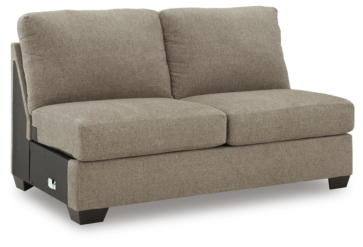 Ashley Furniture Newellen sleeper sectional with chaise, angled view showing plush fabric and modern design.