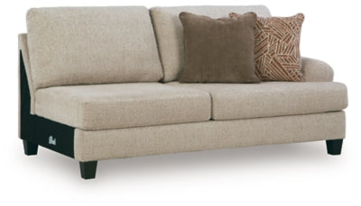 Ashley Furniture Steelwater Retreat sectional with chaise, featuring plush cushions and a modern design in a cozy living room setting.