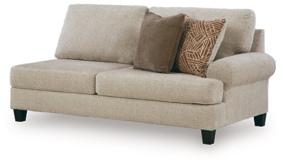 Ashley Furniture Steelwater Retreat sectional with chaise, featuring plush cushions and modern design, shown from an angled side view.