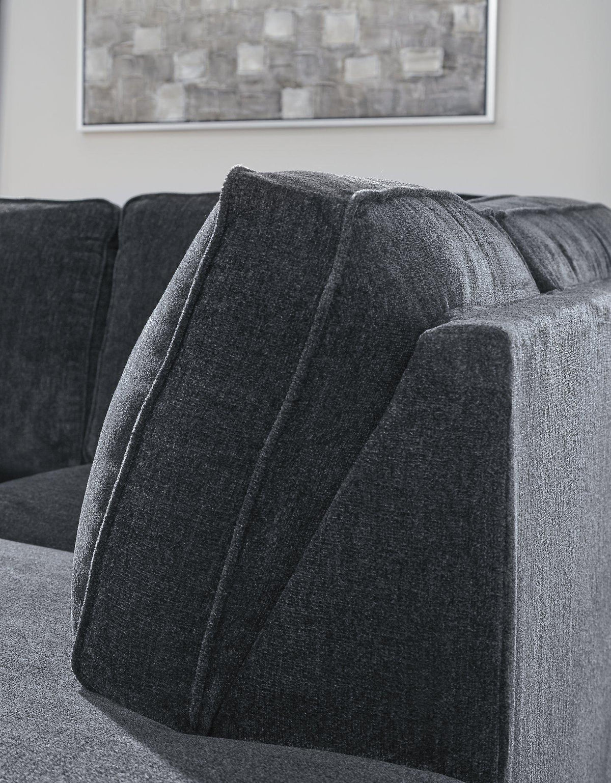 Ashley Furniture Altari sleeper sectional with chaise, featuring plush upholstery and modern design in a stylish living room setup.