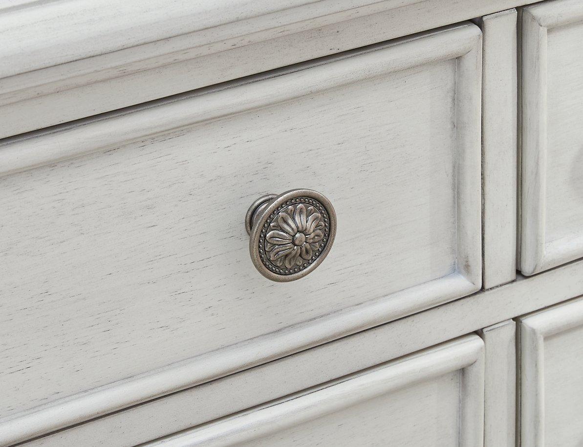 Montelaine dining server by Ashley Furniture featuring a spacious surface and storage drawers in a classic wood finish.
