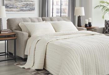 Mahoney Sofa Sleeper by Ashley Furniture, a stylish gray sleeper sofa with plush cushions and a fold-out bed in a modern living room setting.