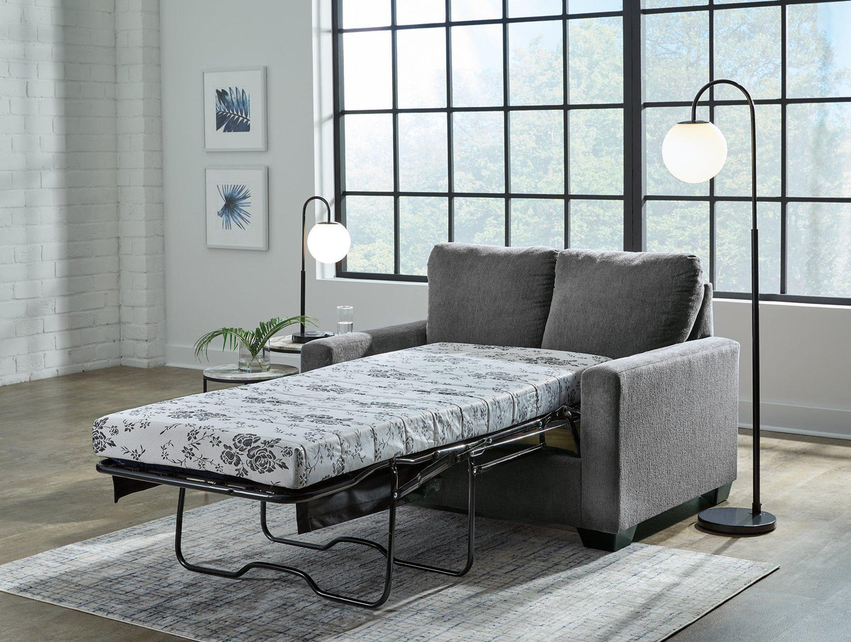 Ashley Furniture Rannis Sofa Sleeper with plush fabric, featuring a fold-out bed and modern design for versatile living space.