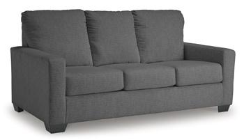 Ashley Furniture Rannis sofa sleeper showing a modern beige sleeper sofa with plush cushions and a fold-out bed in a living room setting.