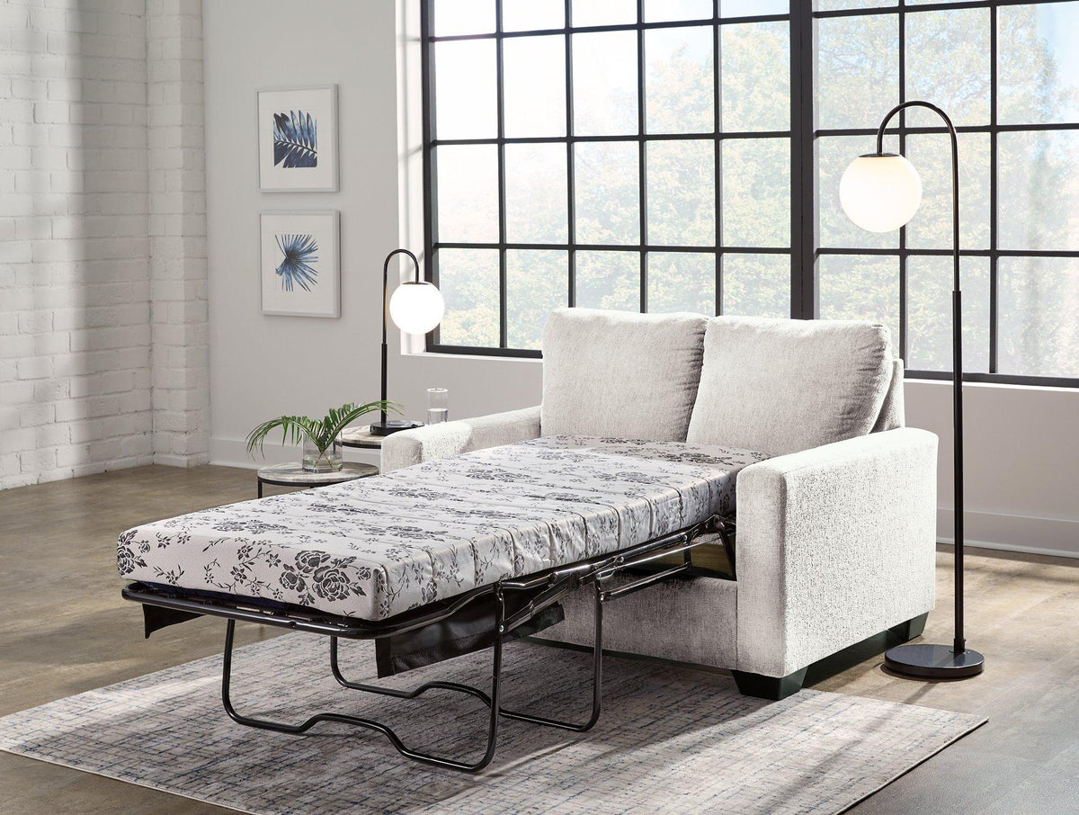 Ashley Furniture Rannis sofa sleeper showing a modern sleeper sofa with plush cushions and a fold-out bed in a stylish living room setting.